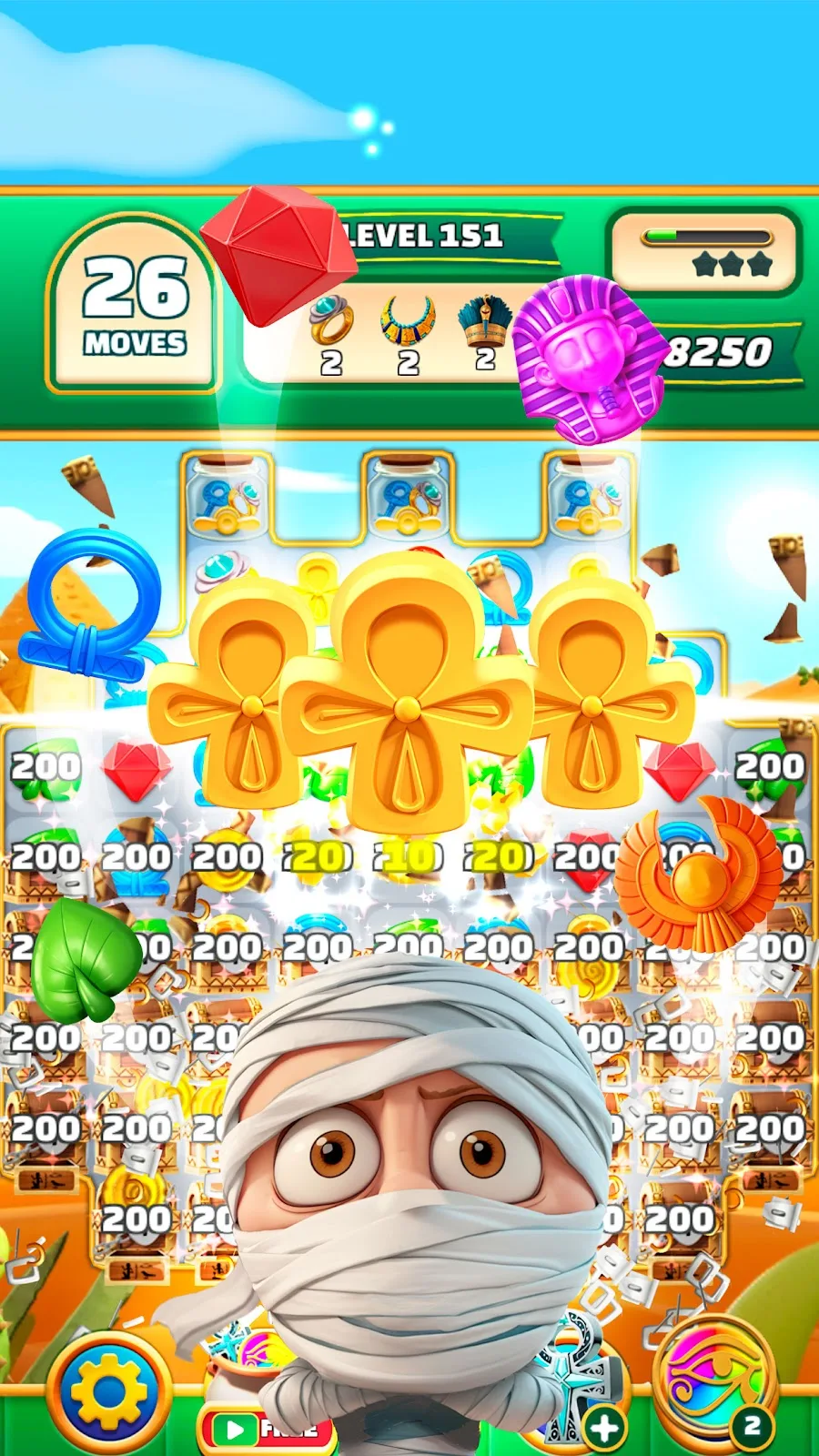 Spielszene aus Gods & Gems: Edelsteine und Göttersymbole auf einem Brett in einer Grabkammer